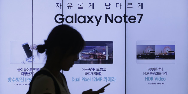 A woman walks by an advertisement of Samsung Electronics Galaxy Note 7 smartphone at the company's showroom in Seoul, South Korea, Friday, Sept. 2, 2016. Samsung Electronics recalled all of its Galaxy Note 7 smartphones on Friday after its investigation found batteries of some of the flagship gadgets caused the phone to explode or to catch fire. (AP Photo/Ahn Young-joon)