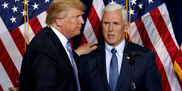 Republican presidential candidate Donald Trump, left, greets vice presidential candidate Gov. Mike Pence as he takes the stage during a campaign rally at the Phoenix Convention Center, Wednesday, Aug. 31, 2016, in Phoenix. (AP Photo/Ross D. Franklin)