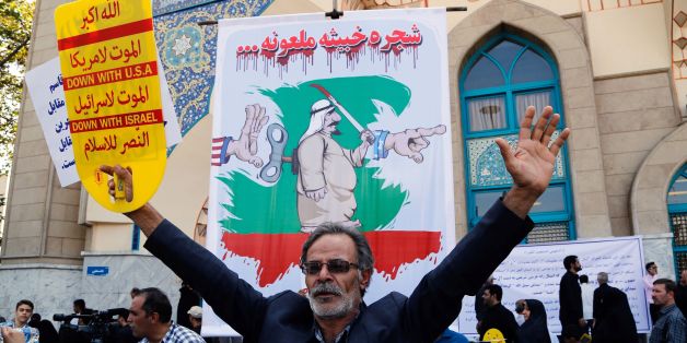 An Iranian man participates in an anti-Saudi demonstration in the capital Tehran on September 9, 2016.With Iranians barred from the annual hajj pilgrimage, thousands protested in Tehran and officials criticised Saudi Arabia's refusal to discuss last year's deadly stampede. The writing on the poster in the background reads in Arabic: Malicious, cursed tree / AFP / afp / STR (Photo credit should read STR/AFP/Getty Images)