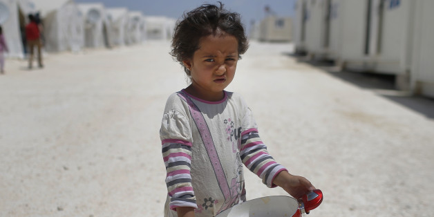 FILE - In this June 19, 2015 file photo, a Syrian refugee child walks at a refugee camp in Suruc, on the Turkey-Syria border. Some 28 million children around the globe have been driven from their homes by violent conflict, with nearly as many abandoning their homes in search of a better life, according to a UNICEF report released Tuesday, Sept. 6, 2016. The report found that while children make up about a third of the world's population as of 2015, they accounted for nearly half of all refugees,