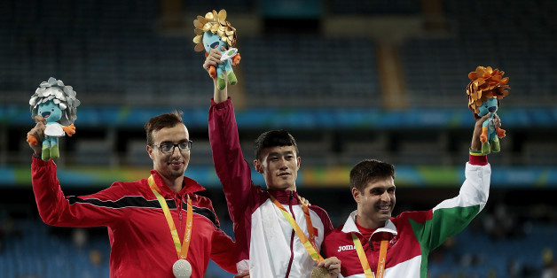 RIO DE JANEIRO, BRAZIL - SEPTEMBER 09: (L-R) Silver medalist Mahdi Afri of Morocco, gold medalist Qichao Sun of China and bronze medalist Luis Goncalves of Portugal celebrate on the podium at the medal ceremony for the Men's 400m T12 Final during day 2 of the Rio 2016 Paralympic Games at the Olympic Stadium on September 9, 2016 in Rio de Janeiro, Brazil. (Photo by Alexandre Loureiro/Getty Images)