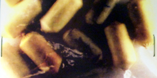 An evidence bag seen July 27, 2000 from an undated U.S. Cutoms photograph shows capsules filled with cocaine and heroin from the stomach of a "drug mule" who was arrested at Miami International Airport. Federal officials say "swallowers" who smuggle cocaine and heroin in capsules in their stomachs are on the rise.CB/JP