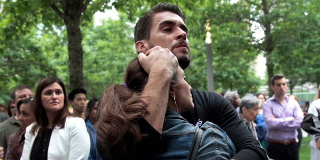 A man and woman embrace during a public tribute to the victims of the mass shooting in an Orlando nightclub, at the 911 Memorial at the site of the World Trade Center in Manhattan, New York, U.S., June 16, 2016. REUTERS/Mike Segar TPX IMAGES OF THE DAY