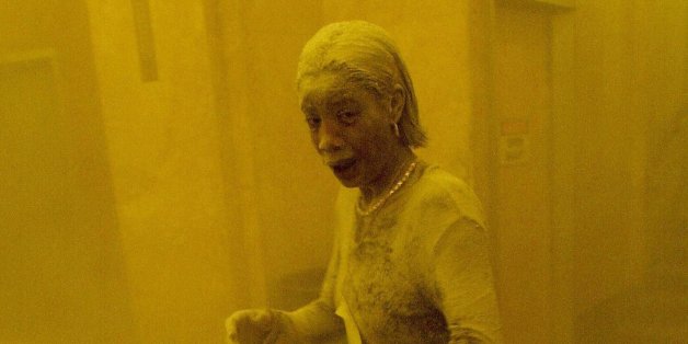 New York, UNITED STATES: TO GO WITH AFP STORY 'Americans mark 9/11 anniversary with new questions on vulnerability' - This 11 September 2001 file photo shows Marcy Borders covered in dust as she takes refuge in an office building after one of the World Trade Center towers collapsed in New York. Borders was caught outside on the street as the cloud of smoke and dust enveloped the area. The woman was caught outside on the street as the cloud of smoke and dust enveloped the area. AFP PHOTO/Stan HONDA (Photo credit should read STAN HONDA/AFP/Getty Images)