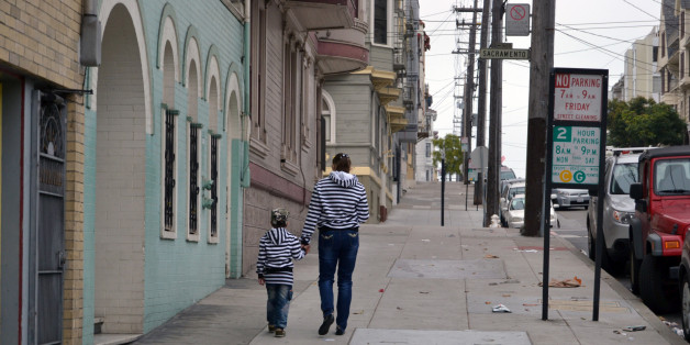 little girl and boy are walking on the street