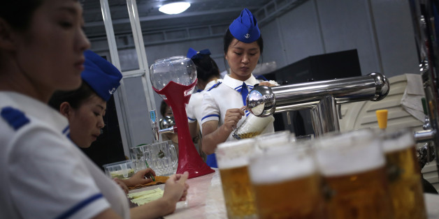 A waitress fill up jugs of beer during Taedonggang Beer Festival in Pyongyang, North Korea, Sunday, Aug. 21, 2016. The festival, the first of its kind in the country, was held as a promotional event for the locally brewed beer. (AP Photo/Dita Alangkara)