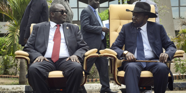 FILE - In this Friday, April 29, 2016 file photo, South Sudan's then First Vice President Riek Machar, left, looks across at President Salva Kiir, as the two sit to be photographed following the first meeting of a new transitional coalition government, in the capital Juba, South Sudan. According to reports from victims which have come to light Monday Aug. 15, 2016, South Sudanese troops, fresh from winning a battle against opposition forces in the capital, Juba, on July 11, 2016, went on a nearly four-hour rampage through a residential compound popular with foreigners, and the U.N. peacekeeping force stationed nearby are accused of refusing to respond to desperate calls for help. (AP Photo/Jason Patinkin, File)