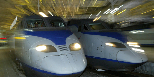 A South Korean KTX train (L) prepares to depart for Pusan city at the Seoul railway station April 1, 2004. South Korea's first high-speed railway service began before dawn on Thursday when a sleek, French-designed bullet train slipped out of Seoul bound for the southern port city of Pusan, now less than three hours away. REUTERS/Kim Kyung-Hoon KKH/GB