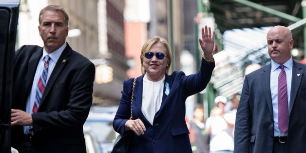 US Democratic presidential nominee Hillary Clinton waves to the press as she leaves her daughter's apartment building after resting on September 11, 2016 in New York.
Clinton departed from a remembrance ceremony on the 15th anniversary of the 9/11 attacks after feeling 'overheated,' but was later doing 'much better,' her campaign said. / AFP / Brendan Smialowski (Photo credit should read BRENDAN SMIALOWSKI/AFP/Getty Images)