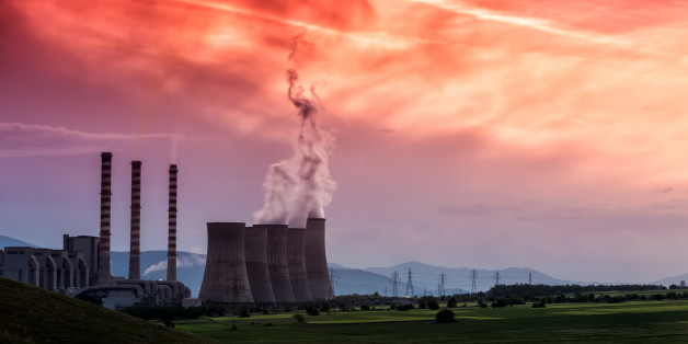 Electric power plant at dusk with orange sky in Kozani Greece