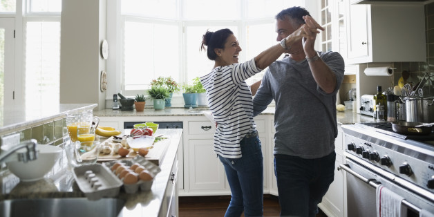Playful couple dancing in kitchen