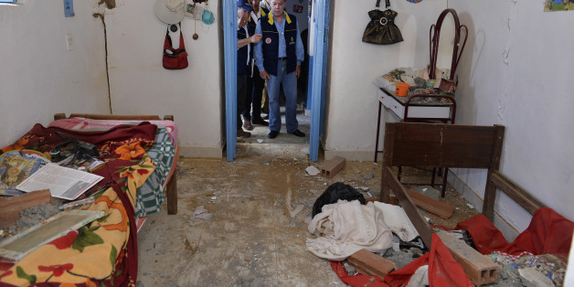 Colombia's President Juan Manuel Santos (C) inspects a house partially damaged by an earthquake in Betulia, Santander province March 11, 2015. A 6.2 magnitude earthquake hit Colombia on Tuesday, shaking buildings in several cities including the capital, Bogota, where residents poured into the streets in panic, but there were no reports of serious injuries or significant damage. The quake's epicentre was located near the eastern city of Bucaramanga, about 272 kilometres (169 miles) northeast of B