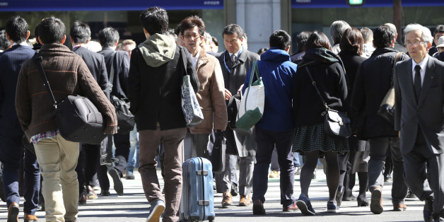 People cross a street in Tokyo, Friday, Feb. 26, 2016. The results of the 2015 census released Friday show the population dropped by 947,000 people in the last five years, the first decline since the count started in 1920. Japan's population stood at 127.1 million last fall, down 0.7 percent from 128.1 million in 2010. (AP Photo/Koji Sasahara)