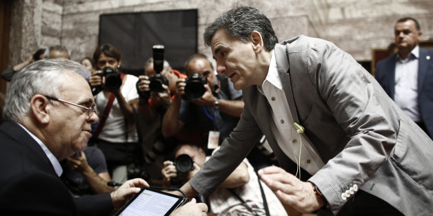 Euclid Tsakalotos, Greece's Finance minister, talks with Yannis Dragasakis, Greece's deputy prime minister, inside the Greek parliament building in Athens, Greece, on Friday, July 10, 2015. In an 11th-hour bid to stay in the euro, the government of Greek Prime Minister Alexis Tsipras offered to meet most of the demands made by creditors in exchange for a bailout of 53.5 billion euros ($59.4 billion). Photographer: Kostas Tsironis/Bloomberg via Getty Images