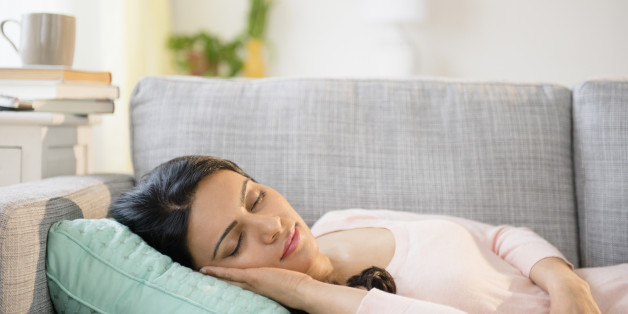 Indian woman napping on sofa