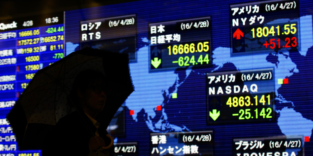 FILE - In this April 28, 2016 file photo, a man looks at an electronic stock indicator of a securities firm in Tokyo as Japanese stocks tumbled 3.6 percent to 16,666.05 and the yen surged after the central bank dashed investors' hopes for more stimulus. Leaders of the Group of Seven rich nations will undoubtedly voice unity over fighting terrorism, pandemics and tax evasion at their summit in Japan starting on Thursday, May 26. Finding a consensus on how to breathe life into their sluggish economies is proving more elusive. (AP Photo/Shizuo Kambayashi, File)