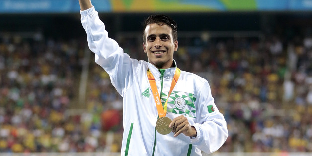 RIO DE JANEIRO, BRAZIL - SEPTEMBER 11: Gold medalist Abdellatif Baka of Algeria celebrate on the podium at the medal ceremony for the Men's 1500m - T13 Final during day 4 of the Rio 2016 Paralympic Games at the Olympic Stadium on September 11, 2016 in Rio de Janeiro, Brazil. (Photo by Alexandre Loureiro/Getty Images)