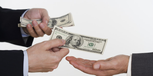 Businessman giving money to a man