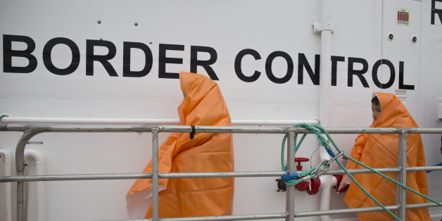 Two children prepare to disembark with other 53 migrants and refugees from a Norwegian Frontex patrol vessel after they were rescued near the shores of the Greek island of Lesbos, Greece, Tuesday, March 22, 2016. The European Union border control agency Frontex says it's seeking 1,500 police officers and 50 readmissions officers from the bloc's member states to help Greece return migrants to Turkey. (AP Photo/Petros Giannakouris)
