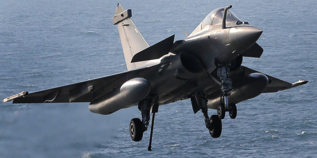 A Rafale fighter jet lands after a mission, on France's flagship Charles de Gaulle aircraft carrier in the Persian Gulf, Wednesday, Jan. 13, 2016. The Charles de Gaulle joined the U.S.- led coalition against Islamic State group in November, as France intensified its airstrikes against extremist sites in Syria and Iraq in response to Islamic State group threats against French targets. (AP Photo/Christophe Ena)