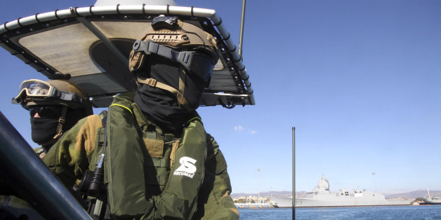 A member of the Norwegian Special Forces looks on during a sea patrol around a Norwegian frigate that docked at Limassol, December 14, 2013. A Danish-led task force was being readied in Cyprus on Saturday to remove the first part of Syria's deadly chemical stockpile, due before the end of this year. Under a deal worked out between the United States and Russia, Syria will relinquish control of deadly toxins which can be used to make sarin, VX gas and other lethal agents. Denmark and Norway plan to use two cargo vessels to transport the cargo out of the Syrian port city of Latakia, escorted by two frigates of their respective navies, and deliver it to the Organisation for the Prohibition of Chemical Weapons (OPCW) for destruction. REUTERS/Andreas Manolis (CYPRUS - Tags: MILITARY POLITICS)