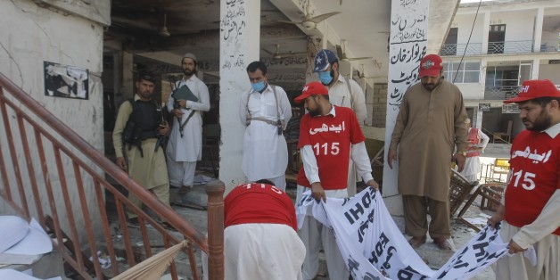 MARDAN, PAKISTAN - SEPTEMBER 2: Pakistani security forces collect evidence after a suicide bomber attacked a court in the northern Pakistani city of Mardan, killing at least 11 people and injuring more than 50, on September 2, 2016. (Photo by Muhammad Asad/Anadolu Agency/Getty Images)