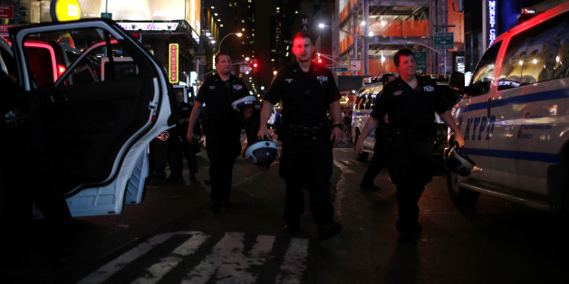 NYPD officers keep an eye on protesters as they go through Times Square taking part in a protest against the killing of Alton Sterling, Philando Castile and in support of Black Lives Matter during a march along Manhattan's streets in New York July 8, 2016. REUTERS/Eduardo Munoz
