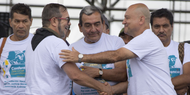 Rodrigo Londono, the top leader of the Revolutionary Armed Forces of Colombia, FARC, also known as Timoleon Jimenez, second from left, is greeted by rebel leaders Carlos Antonio Lozada, and Mauricio Jaramillo, center, after his speech to inaugurate the group's 10th conference in Yari Plains, southern Colombia, Saturday, Sept. 17, 2016. FARC leaders and guerrilla delegates kicked off their last conference as a rebel army as they look to transition into a political movement following the signing o
