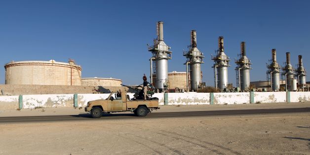 Forces opposed to Libya's unity government ride a truck in the Zueitina oil terminal on September 14, 2016.Forces opposed to Libya's unity government handed management of four vital oil ports to the National Oil Company on September 14, after seizing them in a blow to fragile peace efforts. Prime minister-designate Fayez al-Sarraj called for urgent talks after the ports were captured by forces loyal to Field Marshal Khalifa Haftar, who supports a rival administration in the country's east. / AFP