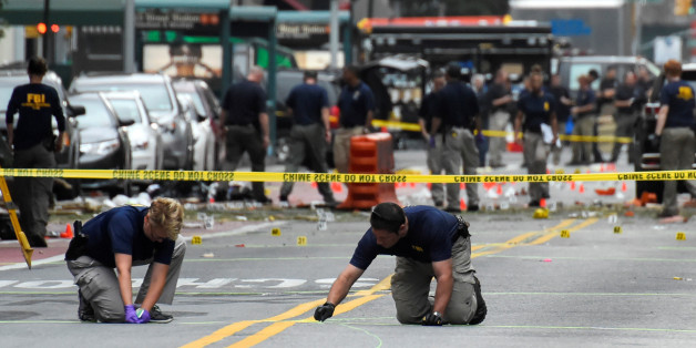 Federal Bureau of Investigation (FBI) officials mark the ground near the site of an explosion in the Chelsea neighborhood of Manhattan, New York, U.S. September 18, 2016. REUTERS/Rashid Umar Abbasi TPX IMAGES OF THE DAY