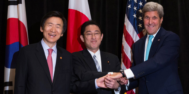 Minister of Foreign Affairs Yun Byung-se of South Korea (L), Minister of Foreign Affairs Fumio Kishida of Japan, and U.S. Secretary of State John Kerry (R) join hands during a meeting between the three leaders in New York, U.S. September 18, 2016. During the meeting, Kerry and ministers from Japan and the Republic of Korea discussed North Korea's nuclear tests in the region. REUTERS/Kevin Hagen/POOL
