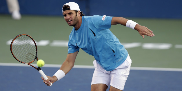Malek Jaziri, of Tunisia, returns a shot to Kevin Anderson, of South Africa, during a semifinal at the Winston-Salem Open tennis tournament in Winston-Salem, N.C., Friday, Aug. 28, 2015. (AP Photo/Gerry Broome)