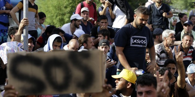 Syrian migrants who have been stranded for days in the northeastern Greek island of Lesvos, gather for travel documents from Greek authorities at the port of Mytilene on Monday, June 15, 2015. An emergency European Union plan to help Italy and Greece manage thousands of migrants crossing the Mediterranean could be vastly watered down on Tuesday, according EU diplomats. During the first five months of 2015, 40,297 migrants arrived in Greece, up from 6,500 in the same period in 2014. Almost all of