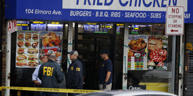 FBI agents walk around the roof outside an apartment during an investigation at a building Monday, Sept. 19, 2016, in Elizabeth, N.J. FBI agents are searching the apartment that is tied to Ahmad Khan Rahami, wanted for questioning in the New York City bombing. (AP Photo/Mel Evans)