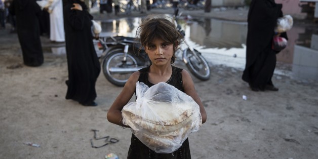 ALEPPO, SYRIA - SEPTEMBER 07 : The Foundation for Human Rights and Freedoms And Humanitarian Relief (IHH) distributes food to Syrians after families who had left the region north of Aleppo are reunited after the opening of the Azez-Jarabulus corridor as the 'Operation Euphrates Shield' continues in Aleppo, Syria on September 07, 2016. The IHH Humanitarian Aid Foundation reached Jarabulus with a 10-vehicle humanitarian aid convoy as part of its 'Hand in hand we are reestablishing Azez-Jarablus' campaign. The anti-Daesh operation called Euphrates Shield, which was launched on August 24, aims at improving security, supporting coalition forces, supporting Syrias territorial integrity and eliminating the terror threat along Turkeys border through Free Syrian Army (FSA) fighters backed by Turkish armor, artillery, and jets.
(Photo by Arif Hudaverdi Yaman/Anadolu Agency/Getty Images)