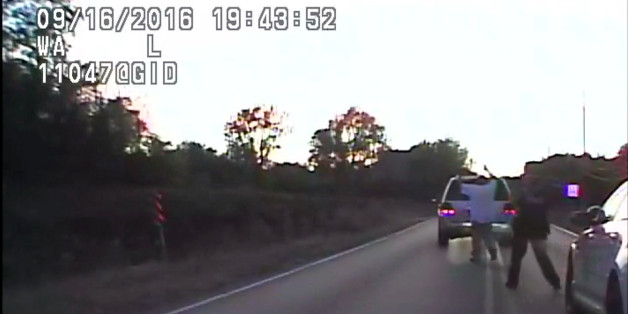 In this image made from a Friday, Sept. 16, 2016 police video, Terence Crutcher, left, is pursued by police officers as he walks to an SUV in Tulsa, Okla. Crutcher was fatally shot Friday after authorities say an officer stopped to investigate the stalled vehicle and Crutcher approached after officers arrived to assist. Crutcher had no weapon on him or in his SUV, Tulsa Police Chief Chuck Jordan said Monday, Sept. 19, 2016. (Tulsa Police Department via AP)