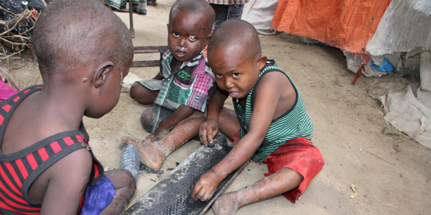Children play on the ground outside their makeshift home in a refugee camp in Mogadishu, Somalia, Tuesday,Sept,20, 2016. A new U.N. report says five million people in Somalia are not getting enough food. That's more than 40 percent of the population of this chaotic Horn of Africa country. The report released Tuesday says the number of people who are food insecure has increased by 300,000 since February. The report says more than 300,000 children under 5 are acutely malnourished. (AP Photo/Farah