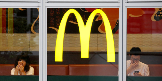 Customers using mobile phones, are seen through the windows of a McDonald's store in Tokyo, Japan July 22, 2016. REUTERS/Toru Hanai/File Photo
