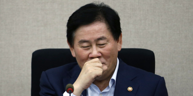South Korea's Finance Minister Choi Kyung-hwan reacts during a meeting with the managing committee of public institutions at the Government Complex in Seoul July 31, 2014. Three turbocharged weeks into his new job, Choi has impressed markets so much that they already talk of "Choinomics" as a brand of new policies aimed at revving up Asia's fourth-largest economy. Picture taken July 31, 2014. REUTERS/Kim Hong-Ji (SOUTH KOREA - Tags: POLITICS BUSINESS)