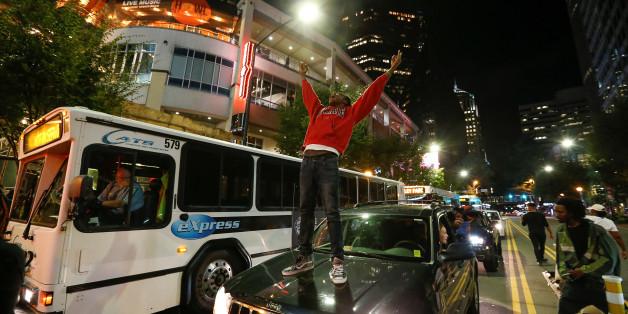 A man stands on a car in uptown Charlotte, NC to protest the police shooting of Keith Scott, in Charlotte, North Carolina, U.S. September 21, 2016. REUTERS/Jason Miczek TPX IMAGES OF THE DAY