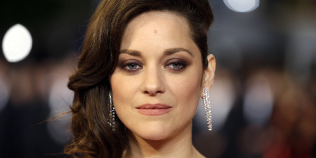 FILE - In this May 19, 2016 file photo, actress Marion Cotillard poses for photographers upon arrival at the screening of the film Juste la Fin du Monde (It's Only the End Of The World) at the 69th international film festival, Cannes, southern France. Cotillard is announcing her pregnancy and shooting down rumors of any romantic involvement with Brad Pitt. The actress says in a statement posted Wednesday, Sept. 21, 2016, on Instagram that she is "not used to commenting on things like this nor ta