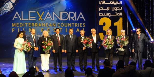 Prize winners of the Alexandria Mediterranean countries film festival stand on stage during the opening ceremony in Egypt's northern coastal city of Alexandria on September 2, 2015. AFP PHOTO / TAREK ABDEL HAMID (Photo credit should read TAREK ABDEL HAMID/AFP/Getty Images)