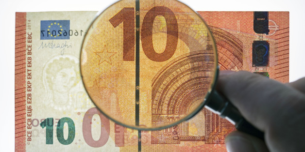 FILE - The Sept. 18, 2014 file photos hows a counterfeit money expert of the German Federal Bank showing the security features of a new ten euro banknote during a press conference at the branch office of the German Federal Bank in Erfurt, central Germany. The 18-countries using the euro currency have a new 10-euro note, which the European Central Bank says has enhanced security features that will make it harder to counterfeit. The new note introduced Tuesday is the second in the bankâs so-called âEuropaâ series, featuring a portrait of the figure from Greek mythology of that name in both the watermark and hologram stripe. The core theme featuring architectural styles from seven periods of European history is unchanged. (AP Photo/Jens Meyer, file)