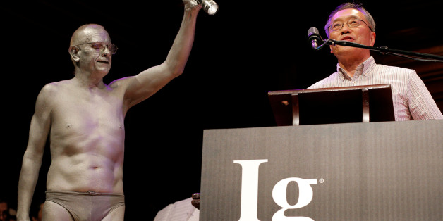 Atsugi Higashiyama of Japan accepts the 2016 Ig Nobel Prize in Perception for "investigating whether things look different when you bend over and view them between your legs" during the 26th First Annual Ig Nobel Prize ceremony at Harvard University in Cambridge, Massachusetts, U.S. September 22, 2016. REUTERS/Brian Snyder