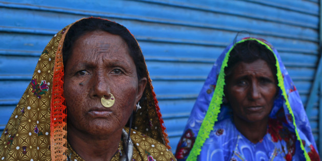 Pakistani Hindu devotees wait outside the Shri Swaminarayan Mandi Temple in Karachi while awaiting transport to pay homage to the Hinglaj Mata Temple in Balochistan April 17, 2011. Every year Hindus from Pakistan and India gather to attend a three-day ritual at the Hinglaj Mata Temple in Balochistan. REUTERS/Akhtar Soomro (PAKISTAN - Tags: SOCIETY)