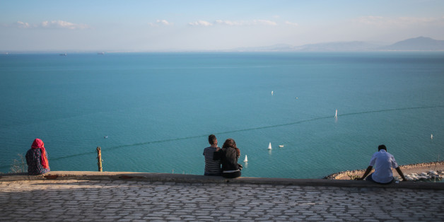 Tourists observe a panoramic view of the Gulf of Tunis from the village of Sidi Bou Said, some 20 kilometers outside of Tunis, Tunisia, Tuesday, Oct. 27, 2015. (AP Photo/Mosa'ab Elshamy)