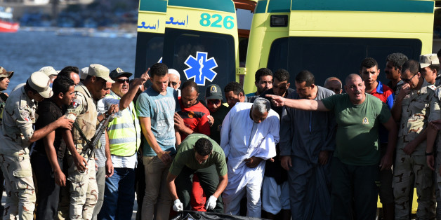 Egyptian medics covers the body of a migrant along the shore in the Egyptian port city of Rosetta on September 22, 2016, during a search operation after a boat carrying migrants capsized in the Mediterranean.A boat carrying up to 450 migrants capsized in the Mediterranean off Egypt's north coast, drowning 42 people and prompting a search operation that rescued 163 passengers, officials said. / AFP / MOHAMED EL-SHAHED (Photo credit should read MOHAMED EL-SHAHED/AFP/Getty Images)