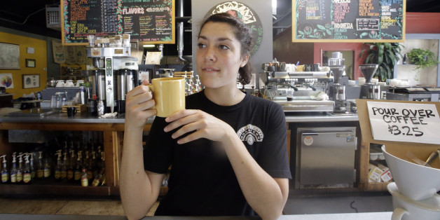 Barista Eviana Dan drinks a cup of coffee at Millcreek Coffee Roasters during National Coffee Day, Tuesday, Sept. 29, 2015, in Salt Lake City. (AP Photo/Rick Bowmer)