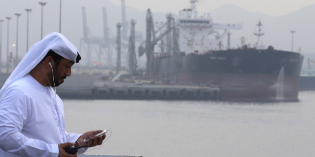 An Emirati man stands at the oil terminal of Fujairah during the inauguration ceremony of a dock for supertankers on September 21, 2016.The oil terminal at Fujairah inaugurated a dock for supertankers, the first of its kind in OPEC member the United Arab Emirates. The facility enables the terminal to receive tankers measuring 334 metres (yards) and weighing 330,000 tonnes, port director Mussa Murad said. / AFP / KARIM SAHIB (Photo credit should read KARIM SAHIB/AFP/Getty Images)