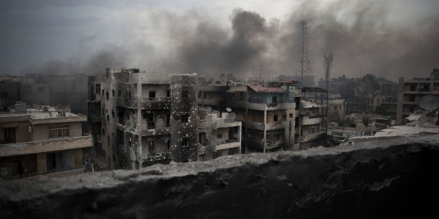 FILE - In this Tuesday, Oct. 2, 2012 file photo, smoke rises over Saif Al Dawla district, in Aleppo, Syria. Residents in the rebel-held districts of Aleppo have a reprieve from the incessant bombings by Syrian government warplanes and the promise of an end to the crippling siege that has left produce stalls bare. (AP Photo/ Manu Brabo, File)